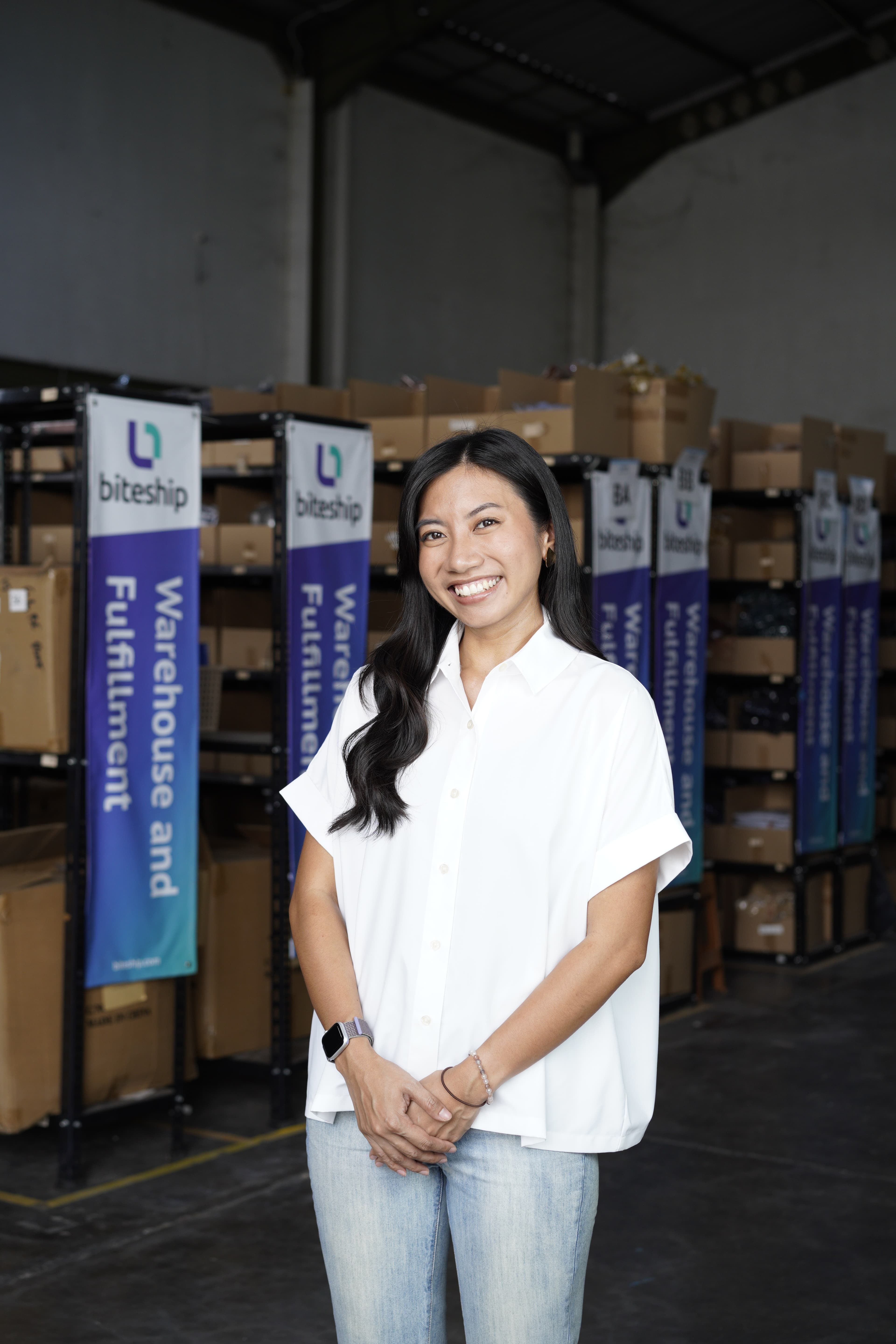 Afra Sausan smiling in a Biteship warehouse