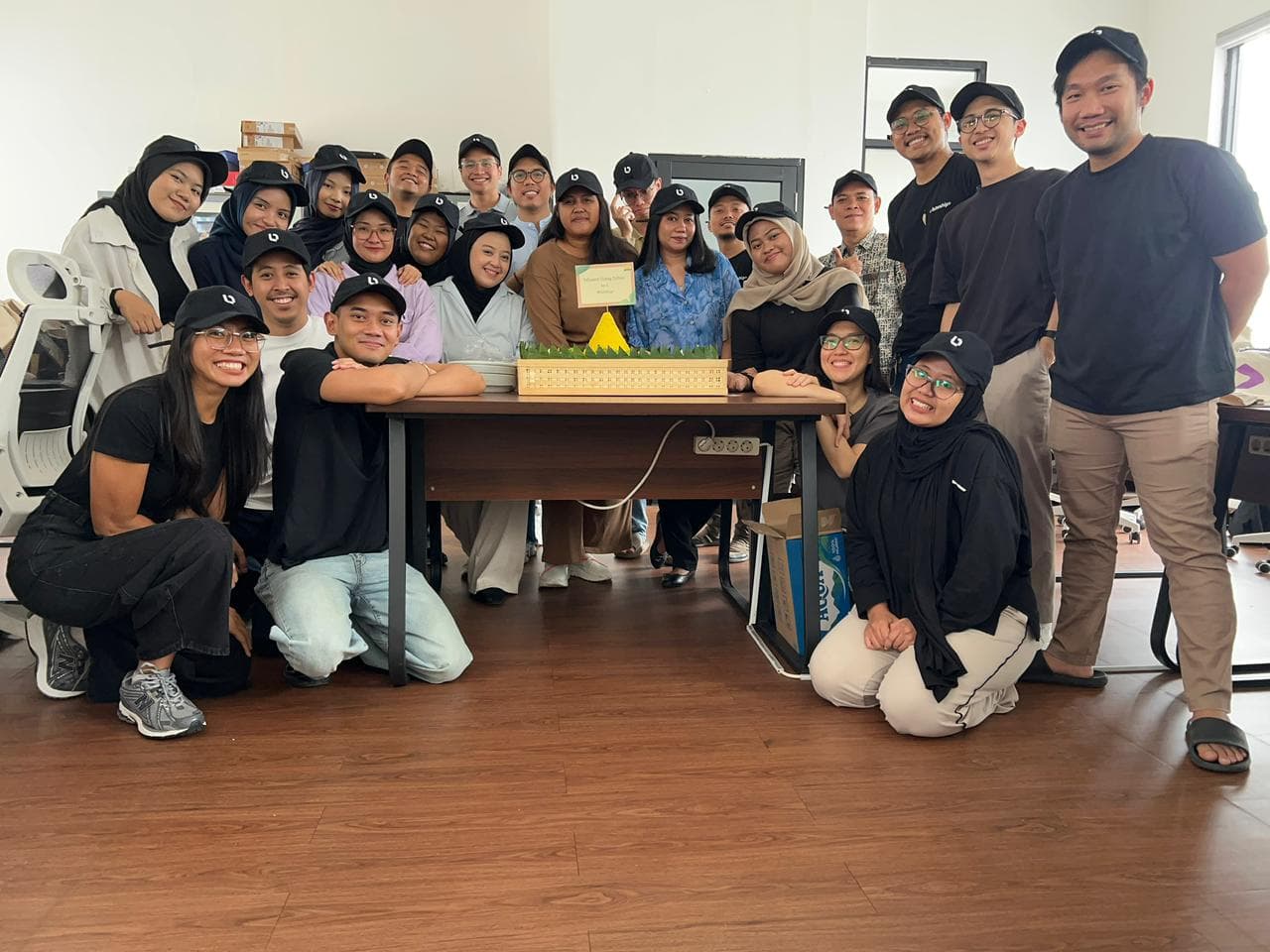 The Biteship team posing together in matching caps