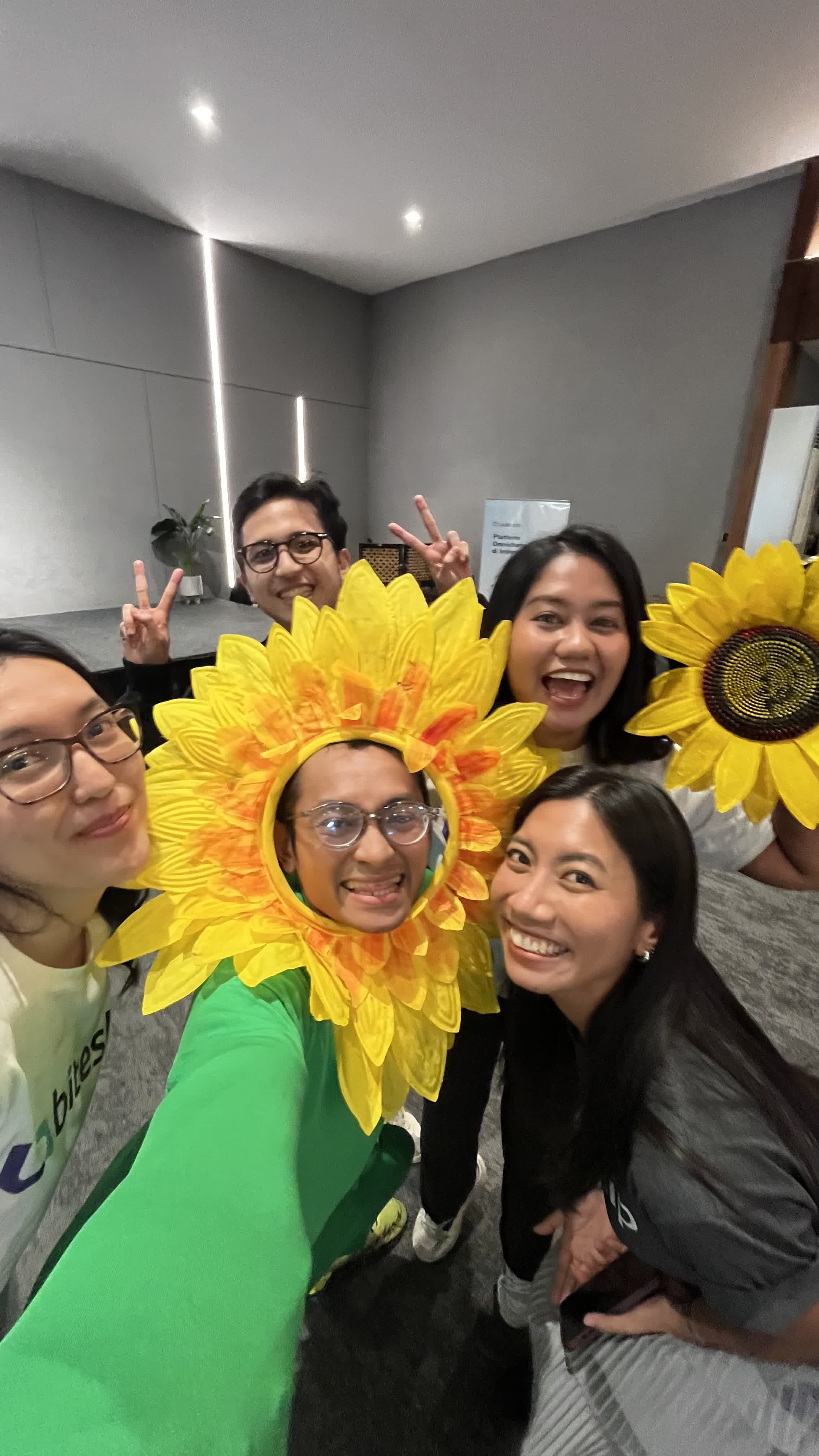 Coworkers posing in sunflower costumes